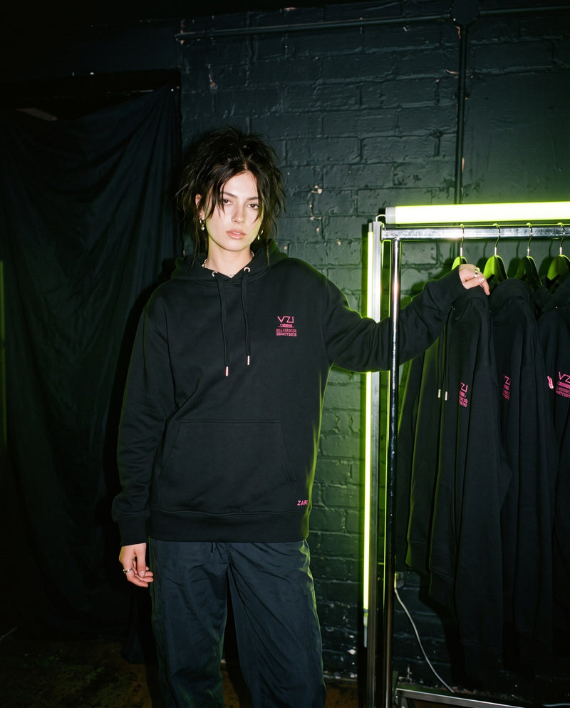 Model wearing Vazzari women's clothing in a neon club setting