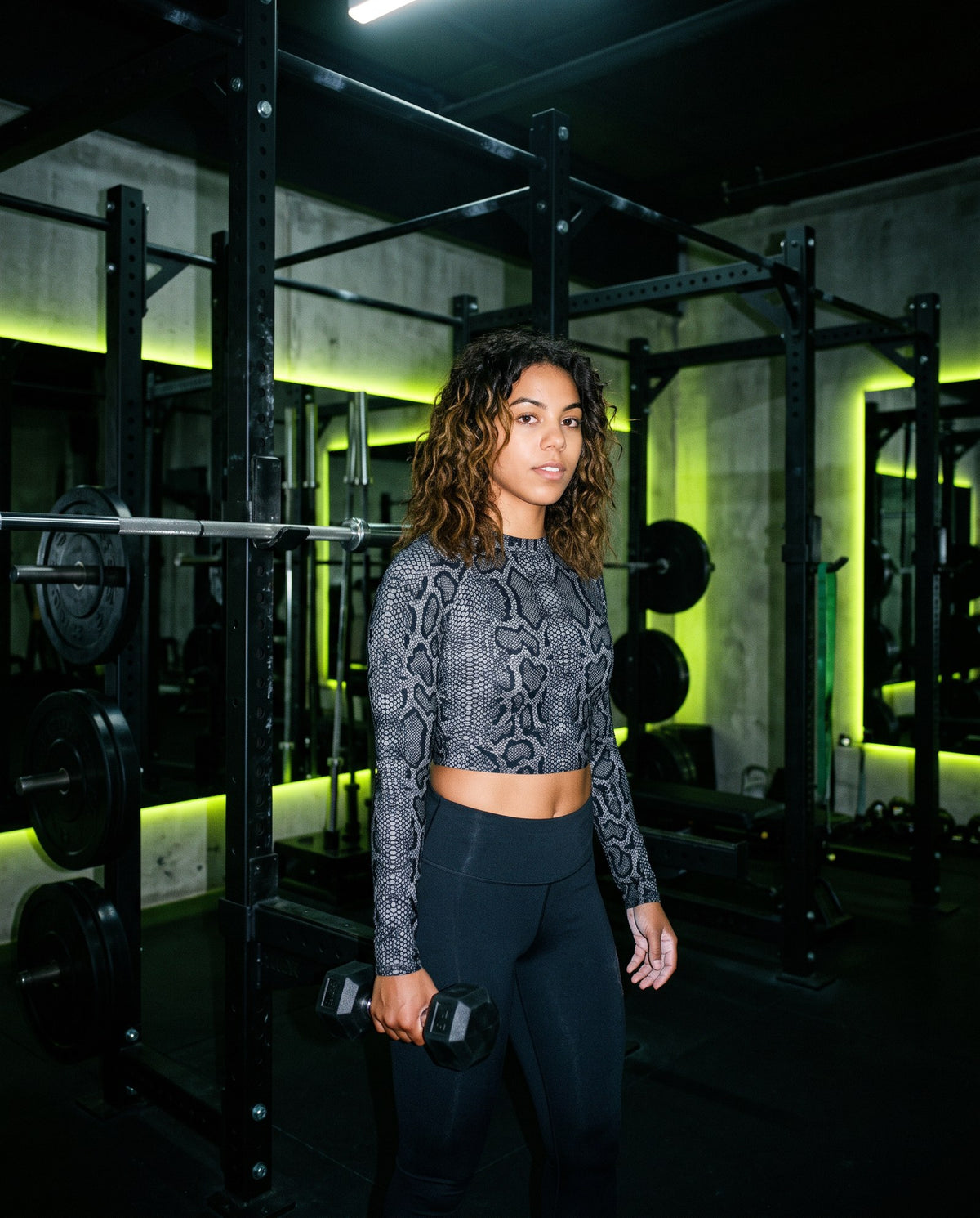 Model wearing Vazzari SuperSport long-sleeve crop top in a gym training setting