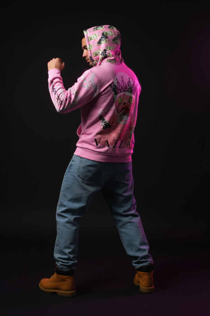 Person wearing a pink hoodie with graphic designs in a neon-lit room