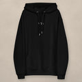 Vazzari Chic Women's Eco Hoodie on beige studio wall