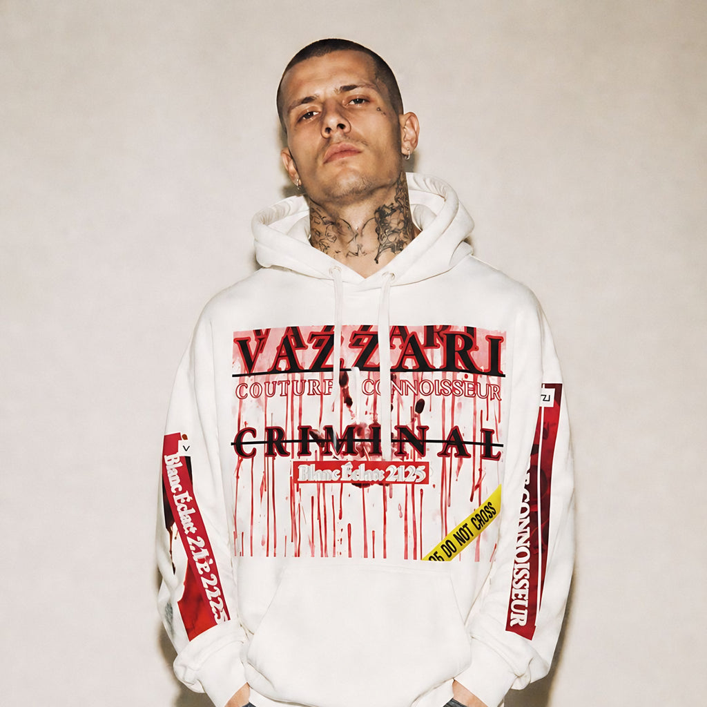 Model wearing the Vazzari Criminal Blanc Hoodie in a beige studio (man)