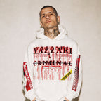 Model wearing the Vazzari Criminal Blanc Hoodie in a beige studio (man)
