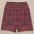 Vazzari Crimson Deities Yoga Shorts on beige studio wall