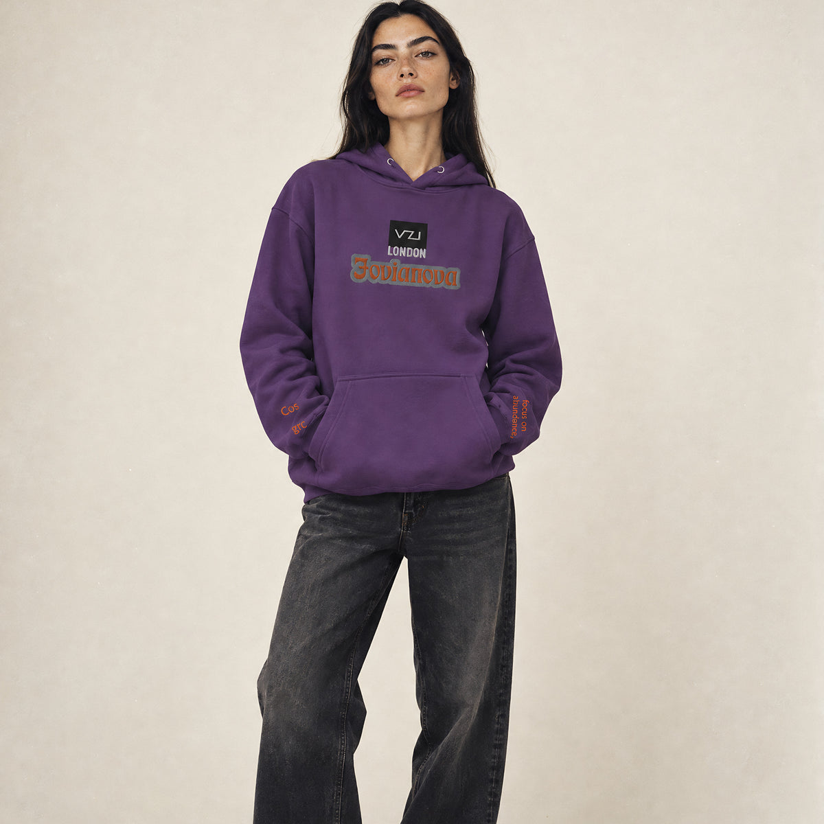 Model wearing the Vazzari Jovianova Hoodie in a beige studio