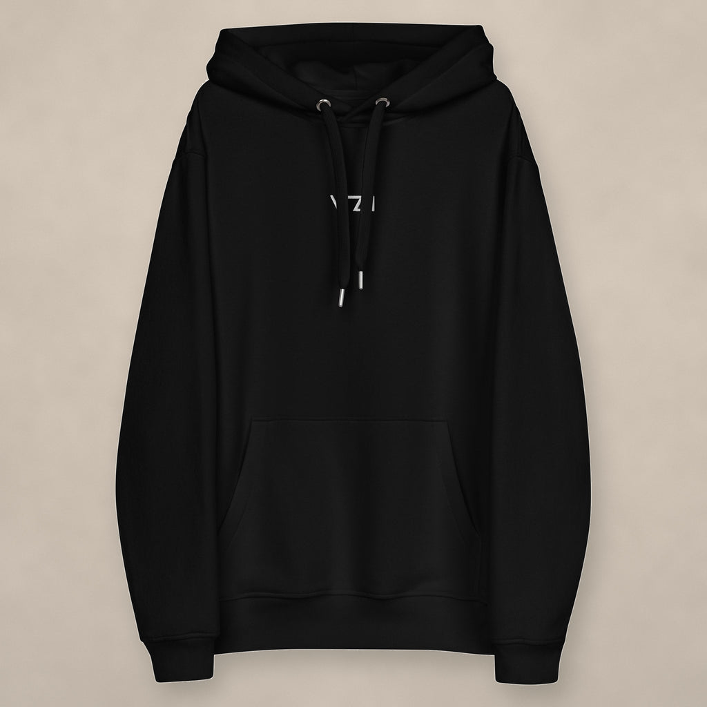 Vazzari Organic Essential Hoodie on beige studio wall