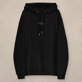 Vazzari Organic Essential Hoodie on beige studio wall