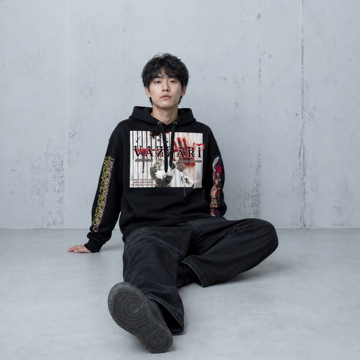 Model wearing the Vazzari Trauma Bonding Hoodie – Noir in a beige studio