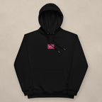 Vazzari Women's Eco Hoodie – Flamingo on beige studio wall